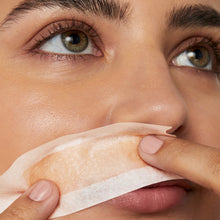 Closeup of a woman's face with a small Flamingo Wax strip applied to her upper lip